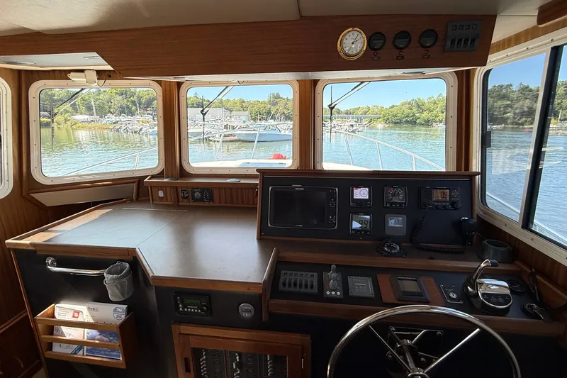 Slide: The Image of Pilothouse of 2012 American Tug 365 with navigation instruments and scenic water view. - 87