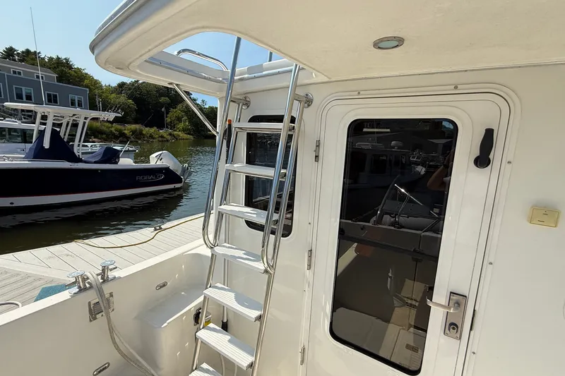 Slide: The Image of 2012 American Tug 365 boat with ladder and docked view. - 28