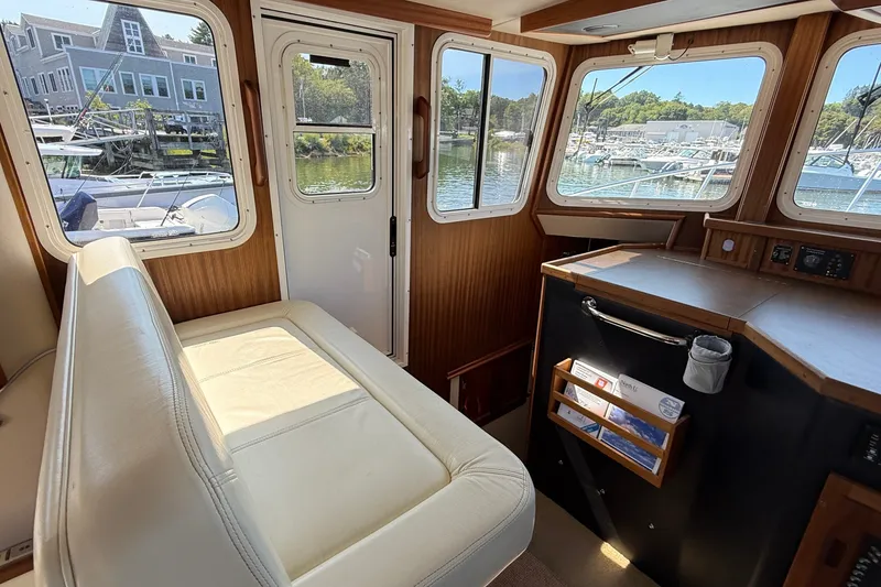 Slide: The Image of Interior of 2012 American Tug 365 with leather seating and large windows overlooking marina. - 82