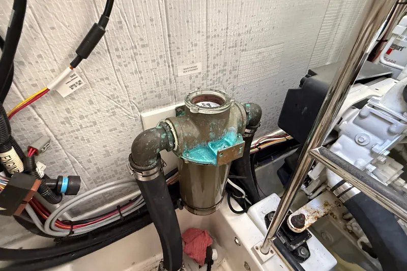 Slide: The Image of Engine compartment of a 2012 American Tug 365 with visible sea strainer and wiring. - 22