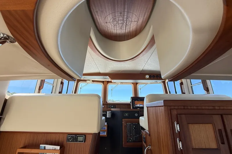 Slide: The Image of Interior view of 2012 American Tug 365, featuring wood accents and navigation equipment. - 78