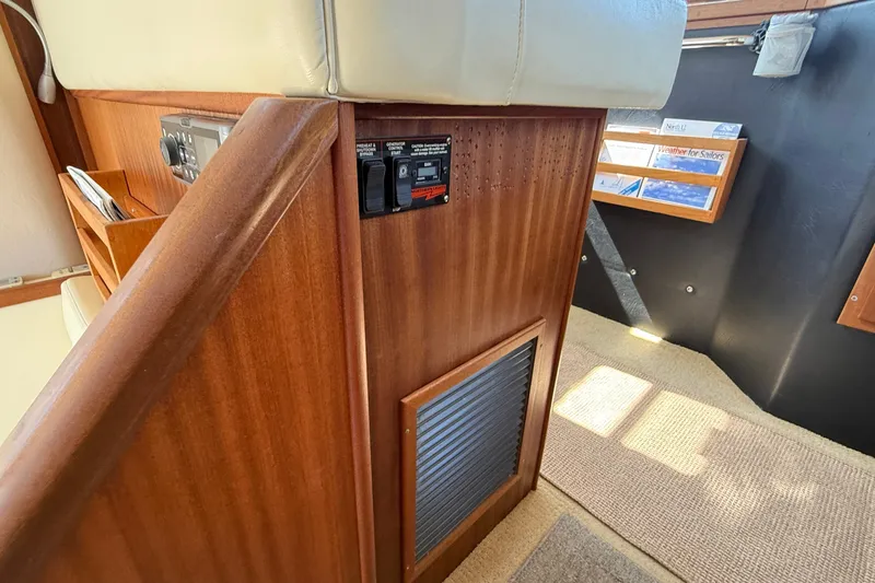 Slide: The Image of Interior of 2012 American Tug 365 with wooden paneling and control switches. - 81