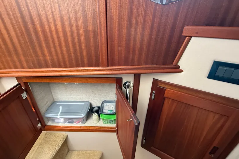 Slide: The Image of Interior storage area of a 2012 American Tug 365 boat with wooden cabinetry. - 110