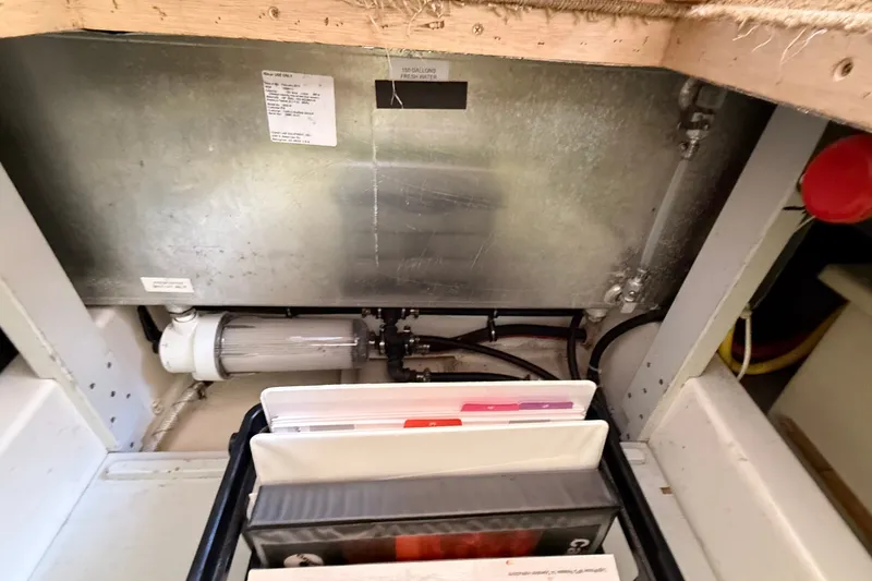 Slide: The Image of Engine compartment of a 2012 American Tug 365 with visible components and storage. - 70
