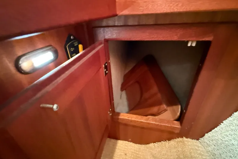 Slide: The Image of Open wooden cabinet in 2012 American Tug 365 boat interior. - 118