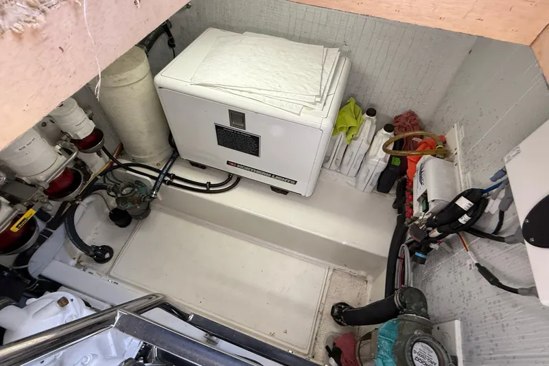 Slide: The Image of Engine room of 2012 American Tug 365 with generator and maintenance supplies. - 18