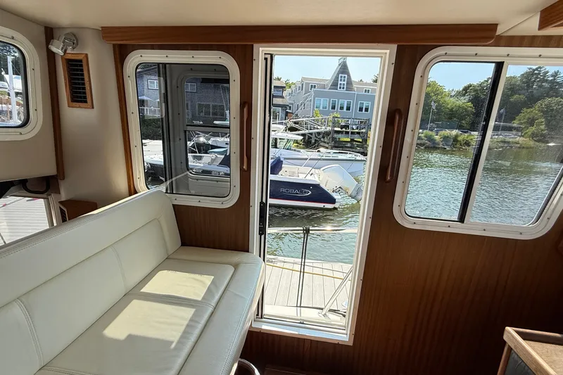 Slide: The Image of Interior view of 2012 American Tug 365 with marina backdrop. - 139