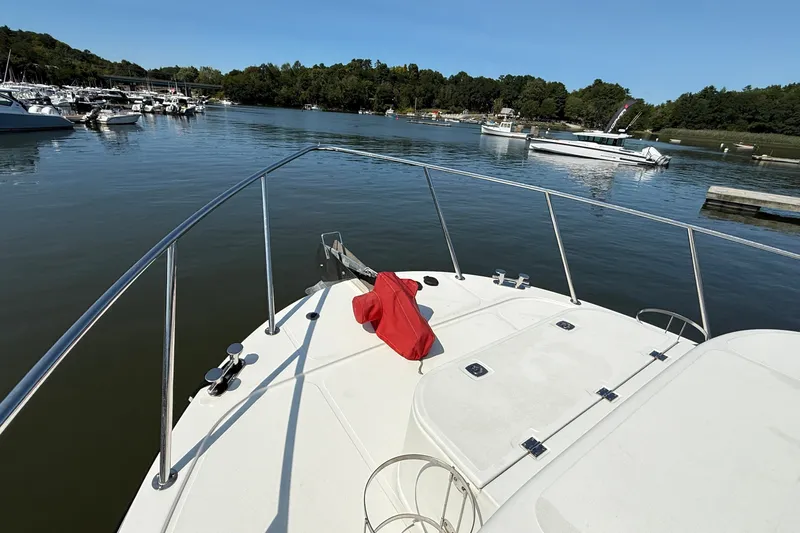 Slide: The Image of Bow view of 2012 American Tug 365 in a serene marina setting. - 3