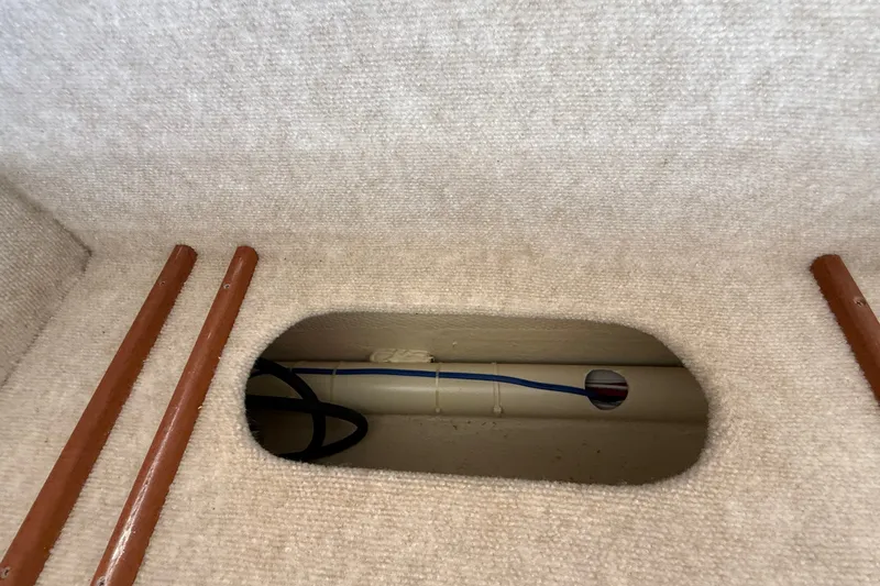 Slide: The Image of Interior view of 2012 American Tug 365, showcasing carpeted flooring and visible wiring. - 74