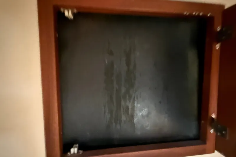 Slide: The Image of Open cabinet door on a 2012 American Tug 365 boat interior. - 125