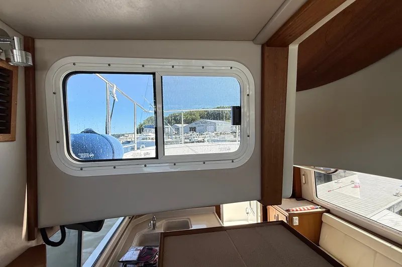 Slide: The Image of Interior view of 2012 American Tug 365, showcasing window and seating area. - 90