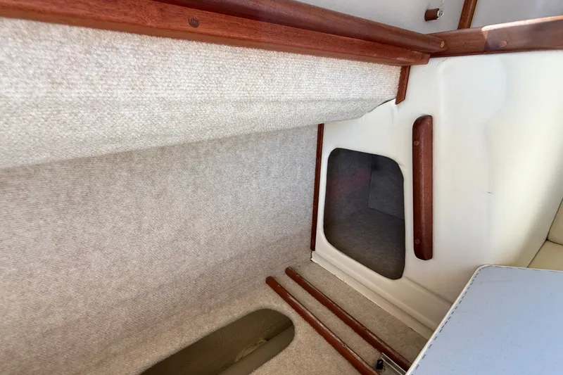 Slide: The Image of Interior view of 2012 American Tug 365, featuring wood accents and carpeted surfaces. - 76