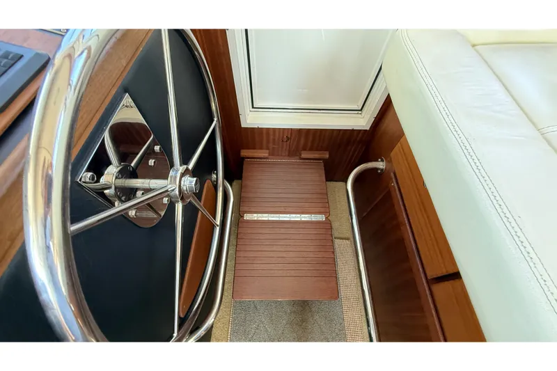 Slide: The Image of Steering wheel and footrest in 2012 American Tug 365 boat interior. - 93
