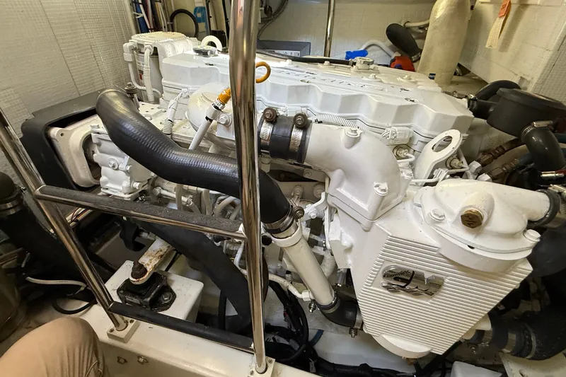 Slide: The Image of Engine room of a 2012 American Tug 365, showcasing a clean, well-maintained marine engine. - 21