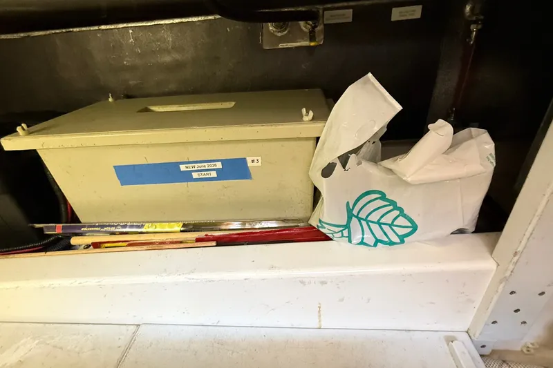 Slide: The Image of Storage compartment in a 2012 American Tug 365 with labeled box and bag. - 68