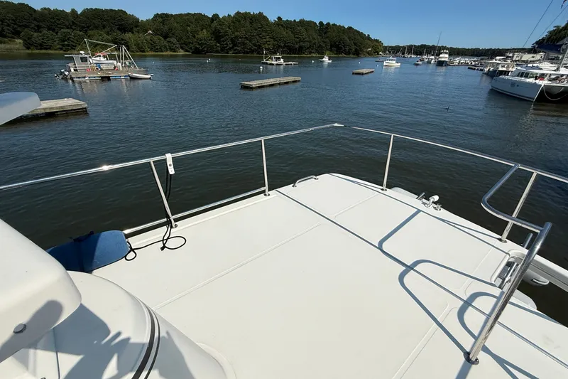 Slide: The Image of American Tug 365 (2012) on calm water, docked with scenic forest backdrop. - 30