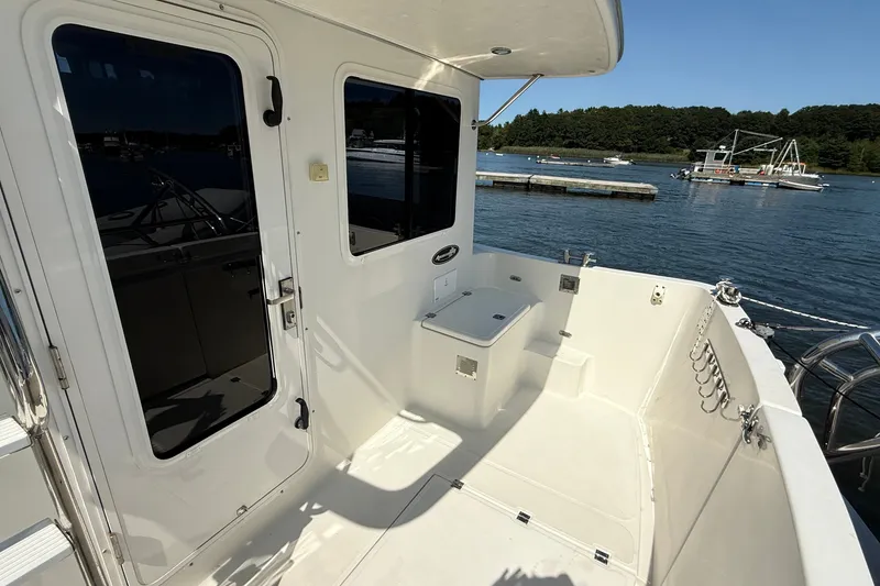 Slide: The Image of American Tug 365 (2012) boat deck with scenic waterfront view. - 16