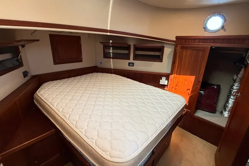 Slide: The Image of Cozy cabin interior of 2012 American Tug 365 with bed and wooden cabinetry. - 113