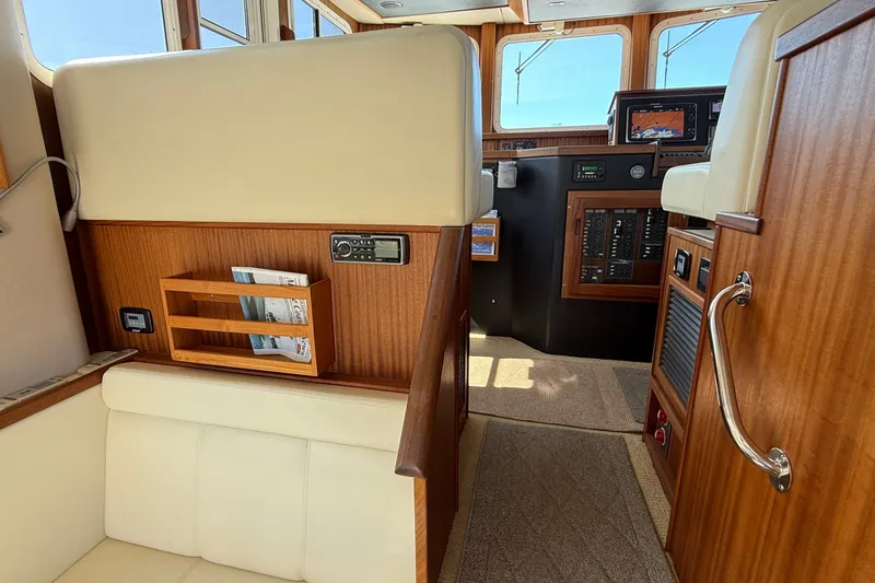 Slide: The Image of Interior of 2012 American Tug 365, featuring wood paneling and navigation equipment. - 79