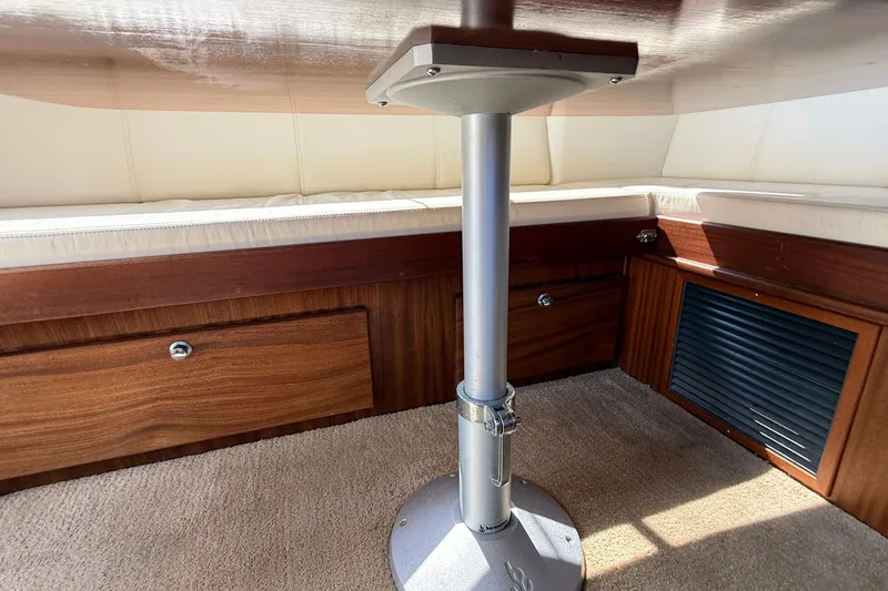 Slide: The Image of Interior of 2012 American Tug 365 with wooden cabinetry and cushioned seating. - 61