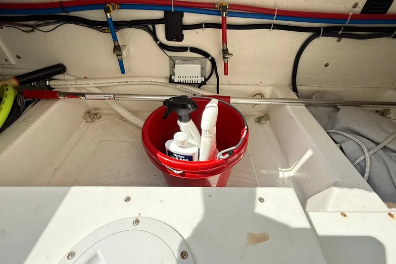 Slide: The Image of Red bucket with cleaning supplies in American Tug 365, 2012 model, boat interior. - 43