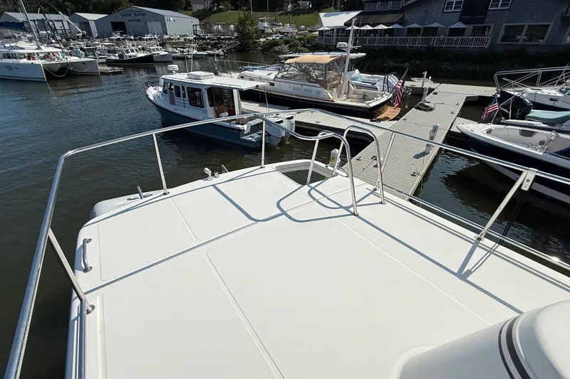 Slide: The Image of American Tug 365 (2012) docked at marina with other boats in background. - 31