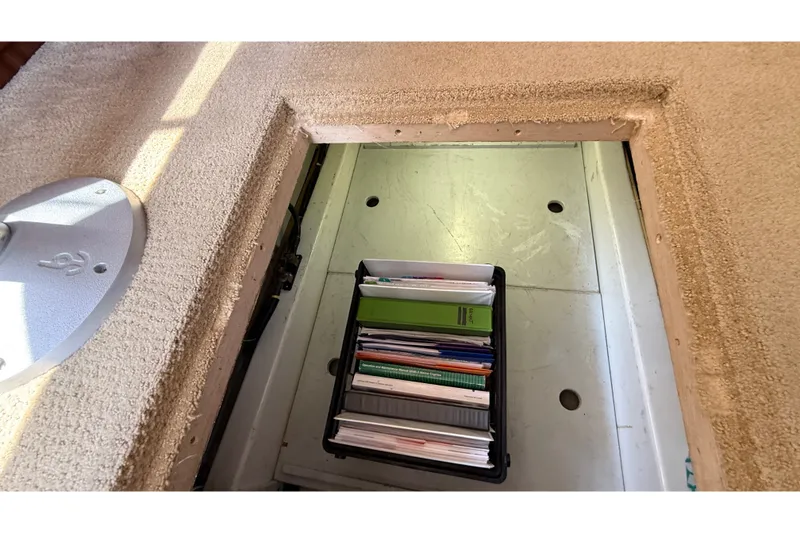 Slide: The Image of Storage compartment with documents on an American Tug 365, 2012 model. - 66