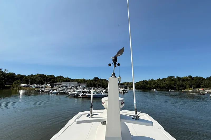 Slide: The Image of American Tug 365 (2012) navigating a serene marina with boats and lush greenery. - 32
