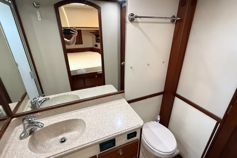 Slide: The Image of Bathroom interior of 2012 American Tug 365 with sink, mirror, and toilet. - 129