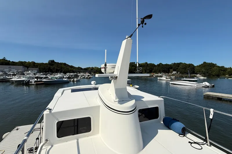 Slide: The Image of American Tug 365 (2012) docked in a marina, surrounded by boats and calm water. - 29