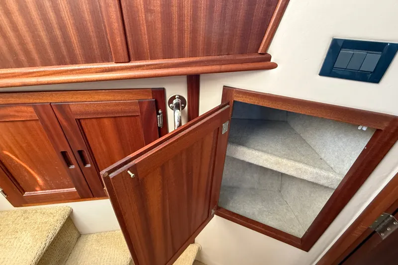 Slide: The Image of Interior of 2012 American Tug 365 showing wooden cabinetry and open storage compartment. - 111