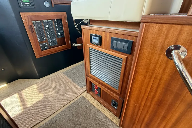 Slide: The Image of Interior of 2012 American Tug 365 showing control panel and wooden cabinetry. - 80