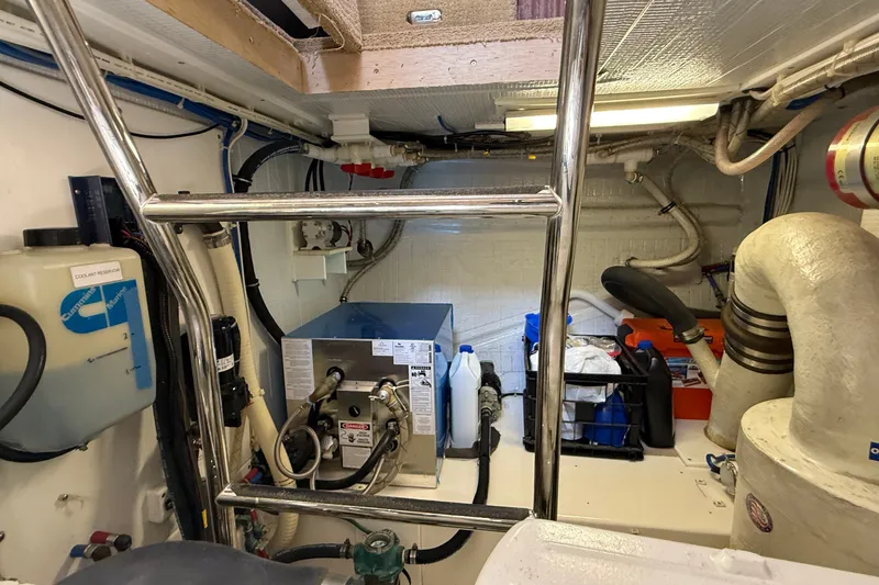 Slide: The Image of Engine room of a 2012 American Tug 365, featuring equipment and storage. - 24