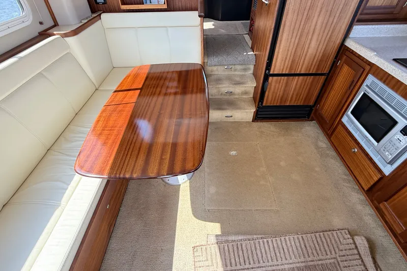 Slide: The Image of Interior of 2012 American Tug 365 featuring dining area and kitchen amenities. - 65