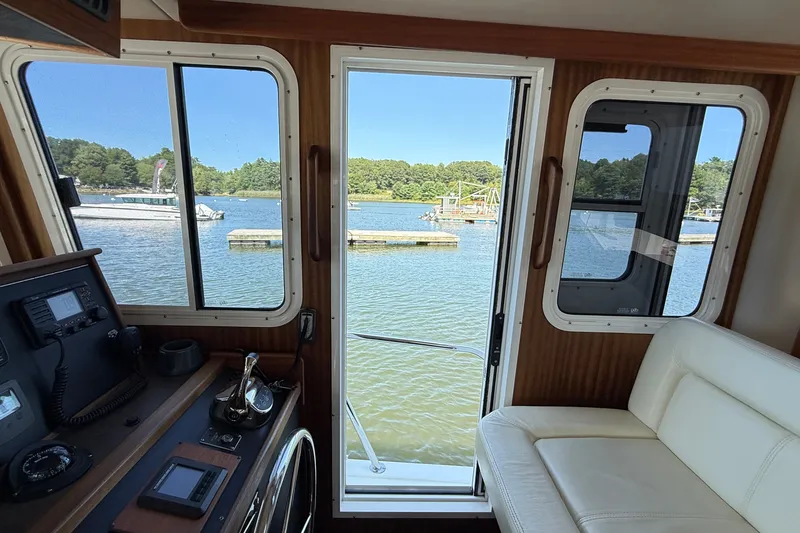 Slide: The Image of Interior view of 2012 American Tug 365, overlooking serene lake and dock. - 137