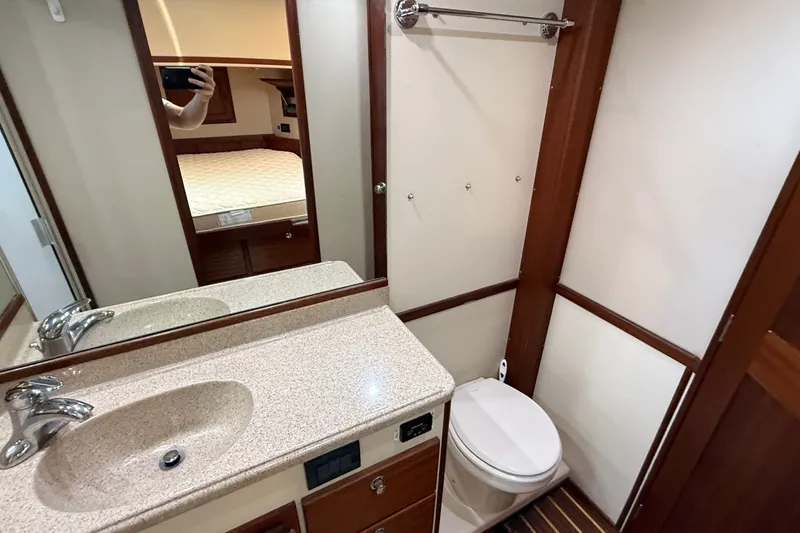 Slide: The Image of Bathroom interior of a 2012 American Tug 365 with sink, toilet, and mirror. - 128