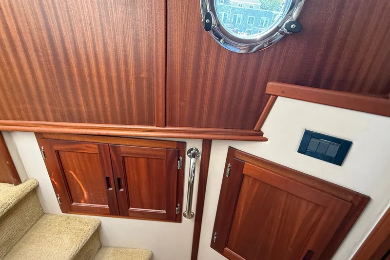 Slide: The Image of Interior of 2012 American Tug 365 with wooden cabinets and porthole window. - 109