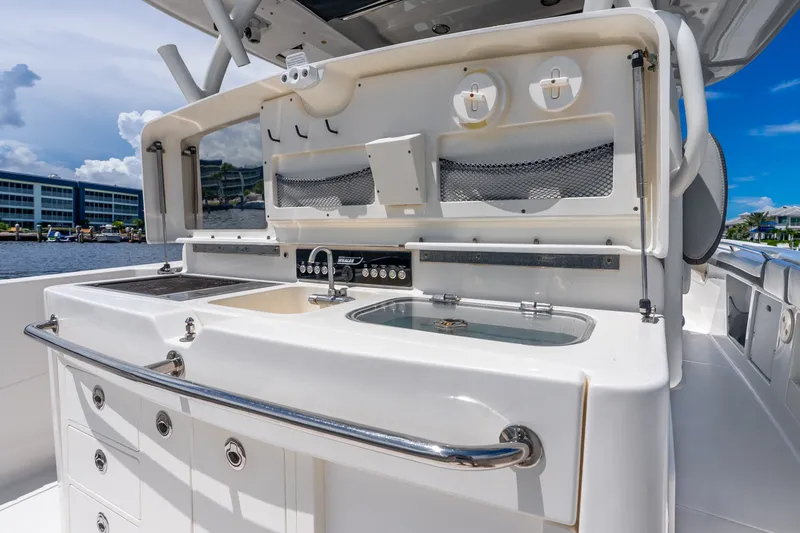 Slide: The Image of Boston Whaler 370 Outrage 2011 boat kitchen area with sink and storage. - 60
