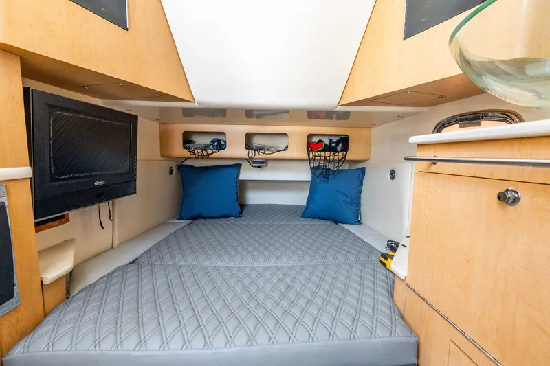 Slide: The Image of Interior cabin of 2011 Boston Whaler 370 Outrage with bed, TV, and storage. - 42