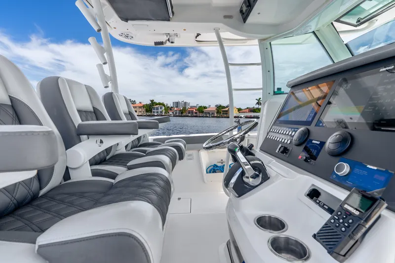 Slide: The Image of 2011 Boston Whaler 370 Outrage helm with modern controls and luxurious seating. - 27