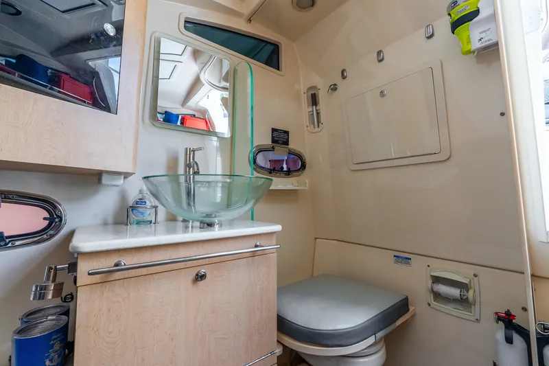 Slide: The Image of Interior of 2011 Boston Whaler 370 Outrage boat bathroom with modern sink and toilet. - 41