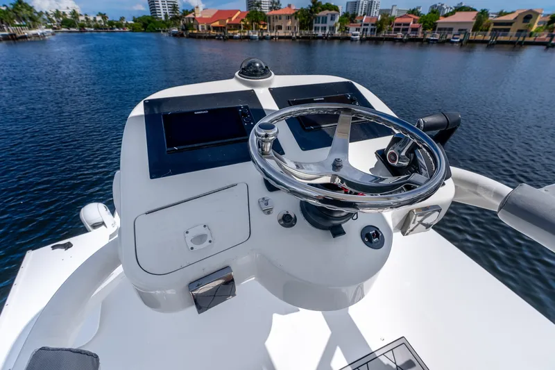 Slide: The Image of Helm of 2011 Boston Whaler 370 Outrage with steering wheel and navigation screens. - 35