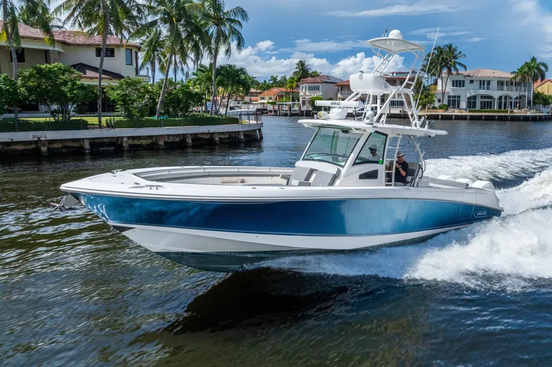 Slide: The Image of 2011 Boston Whaler 370 Outrage cruising on a scenic waterway with palm trees. - 15