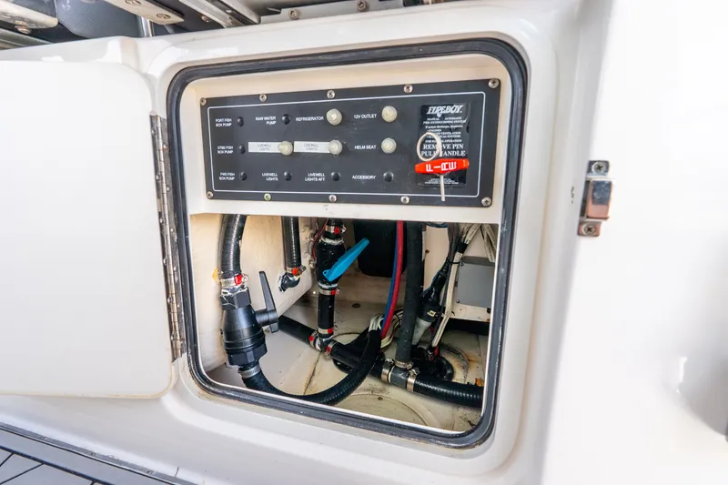 Slide: The Image of Control panel and wiring inside a 2011 Boston Whaler 370 Outrage boat compartment. - 31