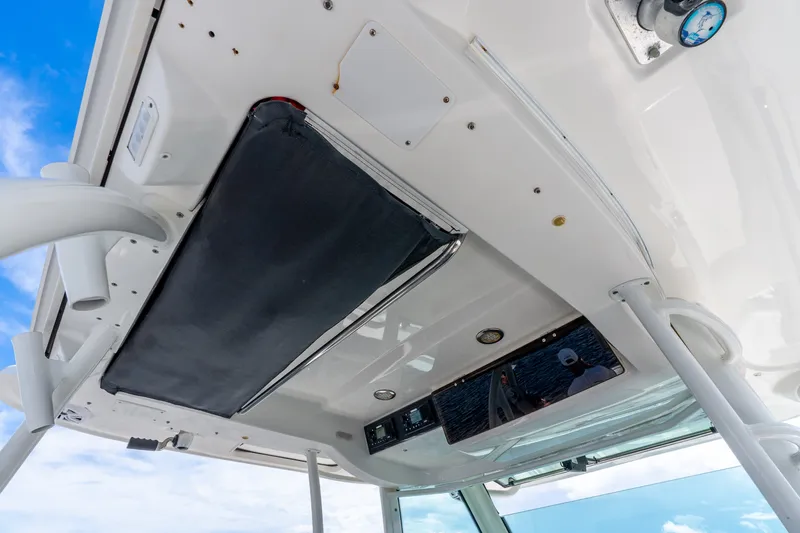 Slide: The Image of Boston Whaler 370 Outrage 2011 boat interior ceiling with storage and controls. - 28