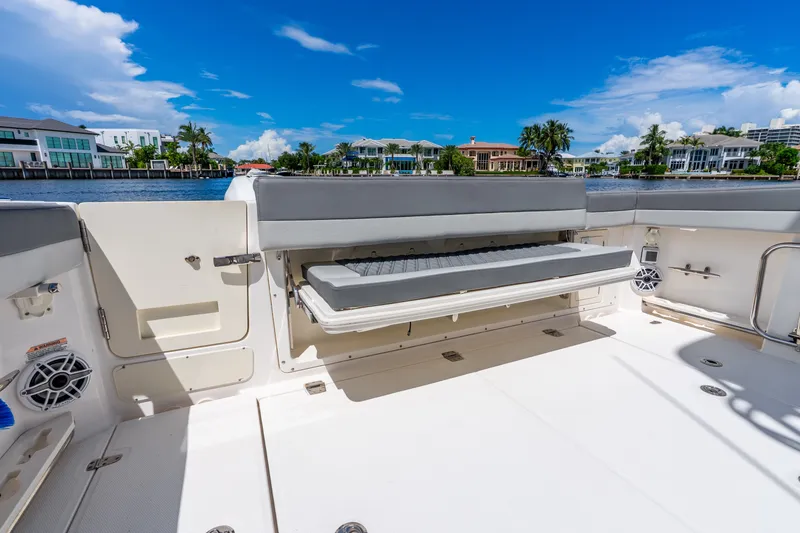Slide: The Image of 2011 Boston Whaler 370 Outrage boat interior with seating, overlooking waterfront homes. - 24