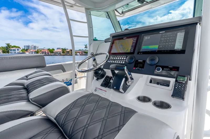 Slide: The Image of 2011 Boston Whaler 370 Outrage helm with advanced navigation displays and luxurious seating. - 25