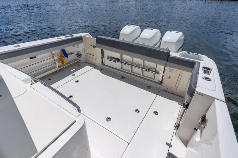 Slide: The Image of 2011 Boston Whaler 370 Outrage boat deck with triple outboard engines. - 55