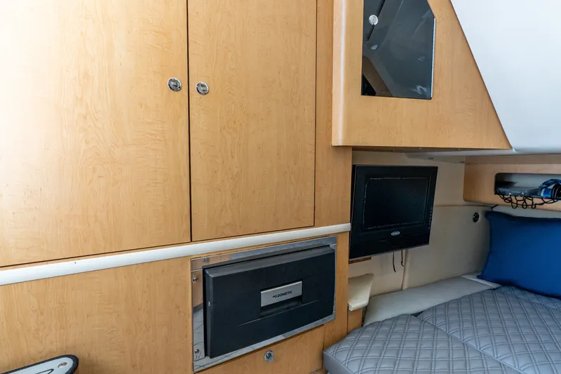 Slide: The Image of Interior cabin of 2011 Boston Whaler 370 Outrage with wood cabinets and bedding. - 43