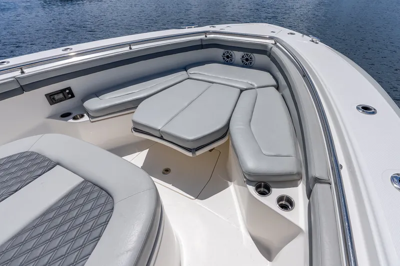 Slide: The Image of 2011 Boston Whaler 370 Outrage boat interior with cushioned seating and cup holders. - 46